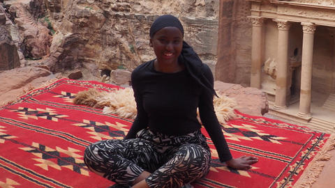student abroad, sitting on a rug