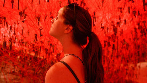 student looking at red sky with keys