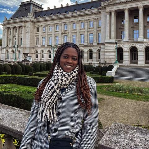 student in front of building