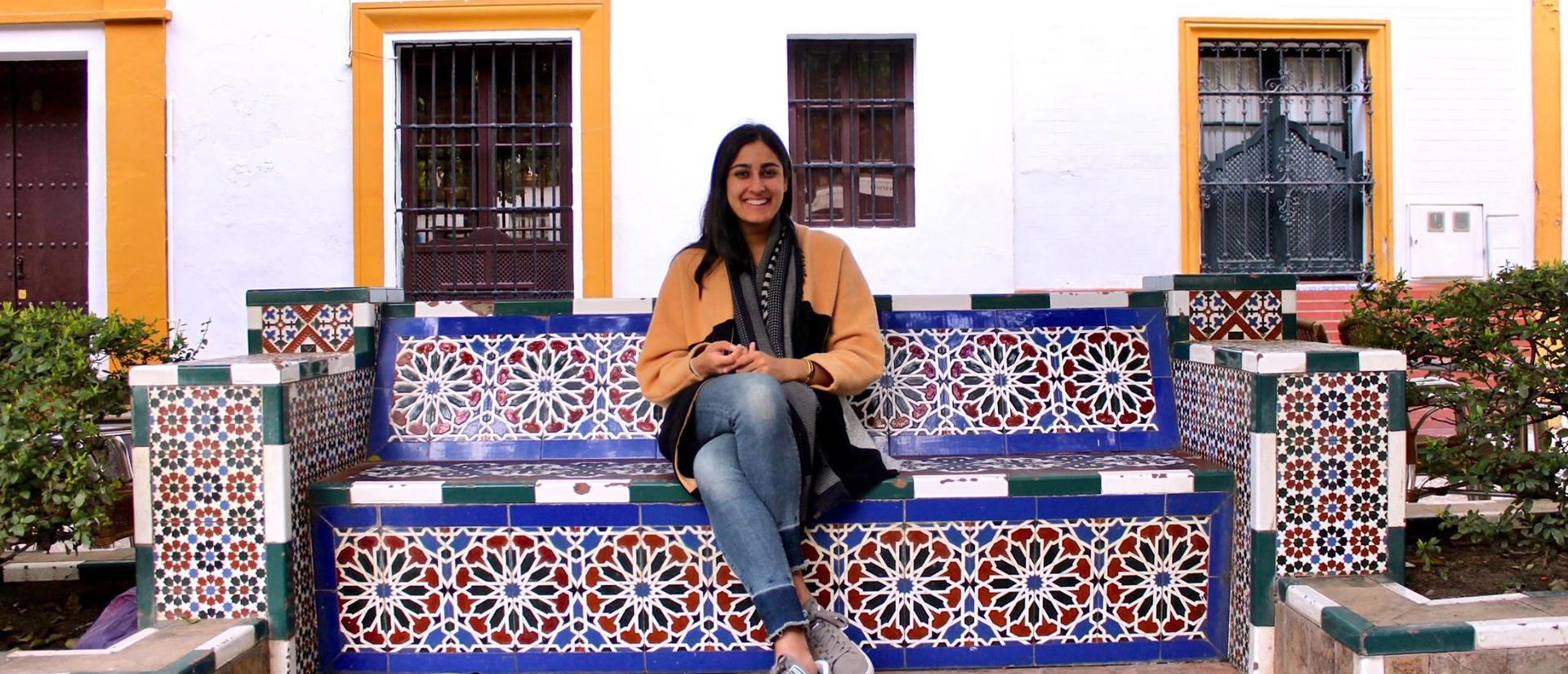 Student sitting on colorful bench