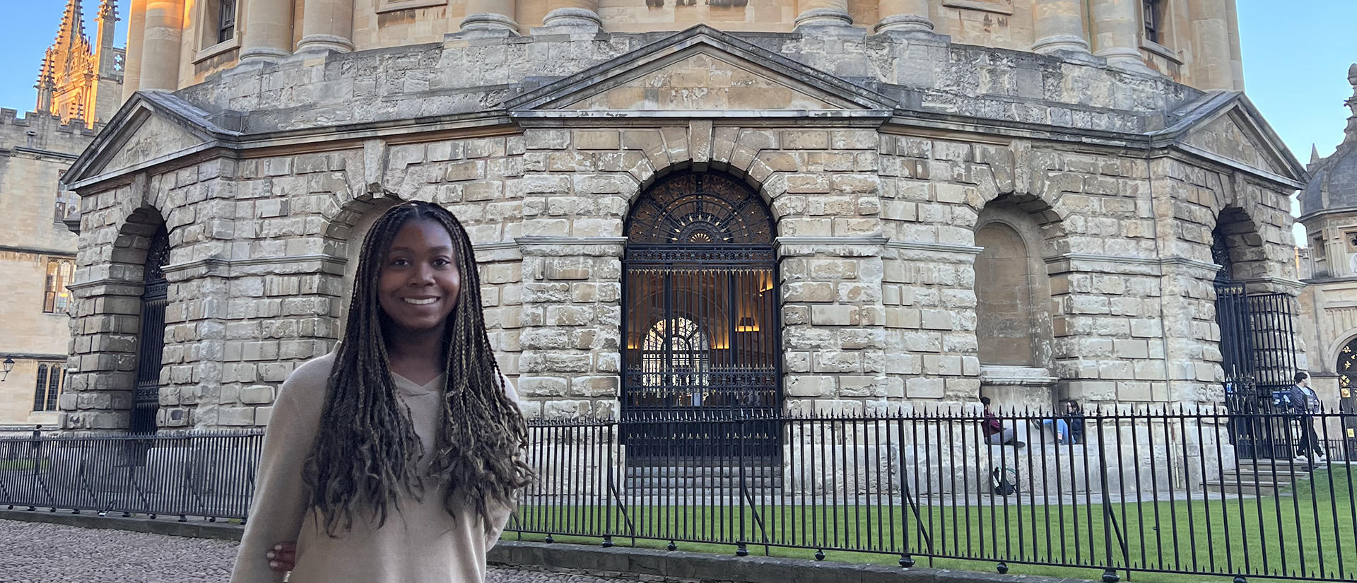 student in front of Oxford building